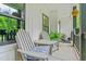 Relaxing front porch features chairs, a small table, and a view of the greenery at 322 Scheer Ave, Durham, NC 27703