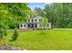 Charming two-story home with well-maintained lawn, landscaping, and mature trees at 322 Scheer Ave, Durham, NC 27703