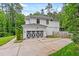 Attached two-car garage with decorative doors and well-maintained landscaping at 322 Scheer Ave, Durham, NC 27703