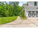 Attached two-car garage with decorative doors and well-maintained landscaping at 322 Scheer Ave, Durham, NC 27703