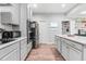 Functional kitchen with stainless steel appliances and an island counter, connecting to the adjacent rooms at 322 Scheer Ave, Durham, NC 27703