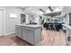 Open-concept kitchen flows into a living area, highlighted by a kitchen island and wood-look floors at 322 Scheer Ave, Durham, NC 27703