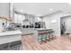 Open kitchen features an island with barstool seating and white cabinetry, flowing into adjacent spaces at 322 Scheer Ave, Durham, NC 27703