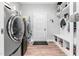 Neat laundry room with washer, dryer, shelving, and a bench for added convenience and storage at 322 Scheer Ave, Durham, NC 27703