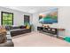 Cozy living room features a sofa, window views, and a modern entertainment center for relaxed living at 322 Scheer Ave, Durham, NC 27703