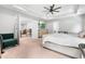 Bright main bedroom showcasing a ceiling fan, furniture, and an open doorway to the loft at 322 Scheer Ave, Durham, NC 27703