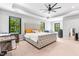 Spacious main bedroom featuring large bed, a ceiling fan, and lots of natural light at 322 Scheer Ave, Durham, NC 27703