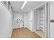 Basement with wood-look flooring features built-in shelves, a utility area, and access to additional space at 3221 Ward Rd, Raleigh, NC 27604