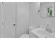 Clean and bright bathroom with white fixtures and a door at 3221 Ward Rd, Raleigh, NC 27604