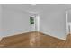 Serene bedroom with hardwood floors, a window, and an adjacent entryway at 3221 Ward Rd, Raleigh, NC 27604