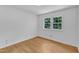 Bright bedroom featuring hardwood floors and a double-hung window at 3221 Ward Rd, Raleigh, NC 27604