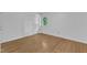 Clean bedroom boasts hardwood floors, a window, and a closet at 3221 Ward Rd, Raleigh, NC 27604