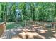 A wood deck overlooks a large backyard, with large mature trees providing shade at 3221 Ward Rd, Raleigh, NC 27604