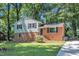 Two-story home features a brick foundation and light siding, complemented by a well-maintained lawn and mature trees at 3221 Ward Rd, Raleigh, NC 27604