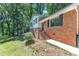 Two-story home with a brick facade and light siding, complemented by landscaped grounds and mature trees at 3221 Ward Rd, Raleigh, NC 27604