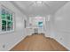 Bright, modern kitchen with white cabinets, stainless steel appliances and an adjacent breakfast nook with hardwood floors at 3221 Ward Rd, Raleigh, NC 27604