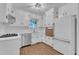 Bright kitchen with stainless steel appliances, white cabinets and view out the window at 3221 Ward Rd, Raleigh, NC 27604