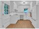Bright kitchen with white cabinets, stainless appliances, and a window over the sink at 3221 Ward Rd, Raleigh, NC 27604