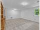Living room has neutral carpet, white walls, windows, and built-in wooden cabinets at 3221 Ward Rd, Raleigh, NC 27604