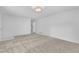 Spacious carpeted living room with staircase access and a minimalist, airy feel at 3221 Ward Rd, Raleigh, NC 27604
