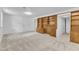 Spacious living area with built-in wooden cabinets and neutral carpeting at 3221 Ward Rd, Raleigh, NC 27604