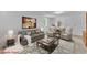 Staged living room features neutral carpet and comfortable seating at 3221 Ward Rd, Raleigh, NC 27604