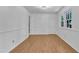 A bright room featuring hardwood floors, white walls, trim and natural light coming in from the windows at 3221 Ward Rd, Raleigh, NC 27604
