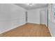 A bright room with hardwood floors, white walls, trim, and natural light coming in from windows at 3221 Ward Rd, Raleigh, NC 27604