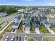 Wide aerial view of a residential area, showcasing a mix of home styles, green spaces, and organized streets at 34 Millennium Dr, Pittsboro, NC 27312