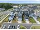 High-angle view of a planned community, featuring various home designs, ample parking, and green surroundings at 34 Millennium Dr, Pittsboro, NC 27312
