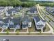 Aerial view of a neighborhood showcasing well-maintained homes, tree-lined streets, and community layout at 34 Millennium Dr, Pittsboro, NC 27312