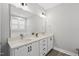 Bright bathroom featuring double sinks and a large mirror at 34 Millennium Dr, Pittsboro, NC 27312