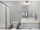 Sparkling bathroom with a glass-enclosed shower, modern vanity, and neutral decor at 34 Millennium Dr, Pittsboro, NC 27312