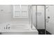 Spacious bathroom features a soaking tub and glass-enclosed shower at 34 Millennium Dr, Pittsboro, NC 27312