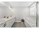 Elegant bathroom featuring double sinks and a luxurious soaking tub at 34 Millennium Dr, Pittsboro, NC 27312