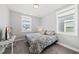 Bedroom with neutral decor and two windows with views of the outside at 34 Millennium Dr, Pittsboro, NC 27312