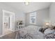 Bedroom featuring neutral decor, window, and open door to another room at 34 Millennium Dr, Pittsboro, NC 27312