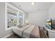 Cozy bedroom with a large window and comfortable bed, creating a relaxing retreat at 34 Millennium Dr, Pittsboro, NC 27312