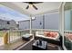 Comfortable covered deck with ceiling fan, cozy seating and a view of the backyard at 34 Millennium Dr, Pittsboro, NC 27312