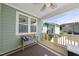 Inviting covered deck with cozy bench, ceiling fan, and relaxing ambiance at 34 Millennium Dr, Pittsboro, NC 27312