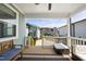 Cozy covered patio with bench seating and view of backyard landscaping at 34 Millennium Dr, Pittsboro, NC 27312