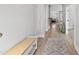 Bright foyer with hardwood floors, rug, bench, coat rack, and ample natural light at 34 Millennium Dr, Pittsboro, NC 27312