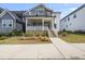 Charming two-story home with a welcoming front porch and beautifully landscaped front yard at 34 Millennium Dr, Pittsboro, NC 27312
