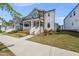 Inviting home exterior with a covered front porch and well-maintained lawn, perfect for Gathering living at 34 Millennium Dr, Pittsboro, NC 27312