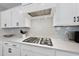 Close up of gas stove with backsplash and stainless vent at 34 Millennium Dr, Pittsboro, NC 27312