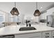Kitchen island with sink and view into the open dining room and living room at 34 Millennium Dr, Pittsboro, NC 27312