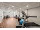 Finished basement area with wood-look floors, white brick walls, exercise equipment, and dinette set at 3540 Rugby Rd, Durham, NC 27707