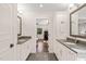 Spacious bathroom featuring double sinks, grey countertop, and access to the bedroom and closet space at 3540 Rugby Rd, Durham, NC 27707