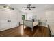 Bright bedroom with hardwood floors, two windows and a ceiling fan, filled with natural light at 3540 Rugby Rd, Durham, NC 27707