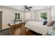 Cozy bedroom with a desk, hardwood floors, two windows and neutral paint, perfect for relaxation and study at 3540 Rugby Rd, Durham, NC 27707